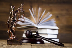 Law books, gavel, and statue of lady justice sitting on the desk of a Real Estate Litigation Attorney Montana